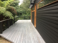 Contrasting Alis grey stain on the deck with the black Alis on the weatherboards.
